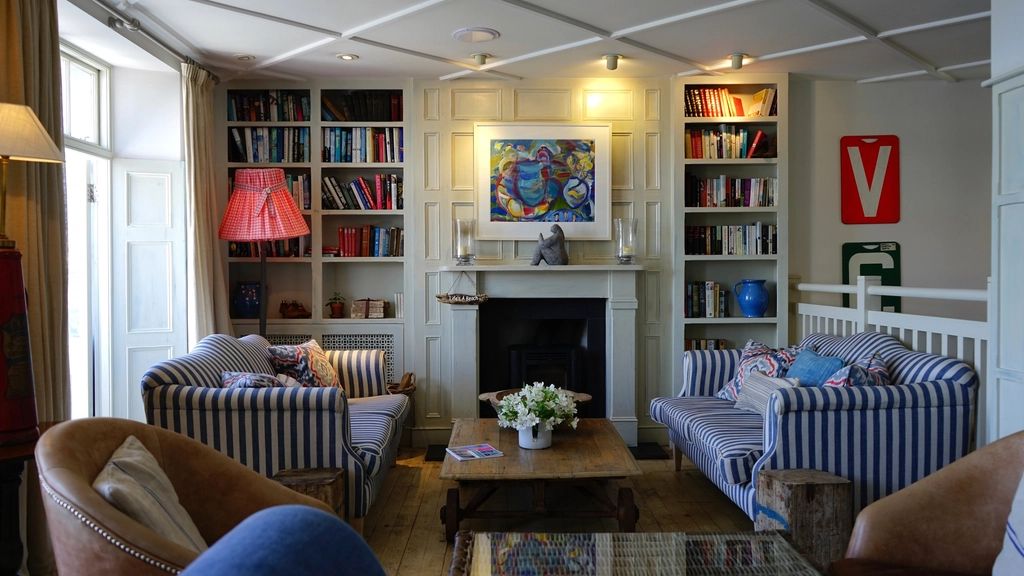 A suite sitting room with a sofa and armchairs